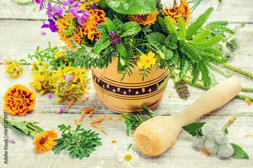 Herbs in a mortar. Medicinal plants. Selective focus.   photo