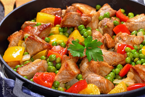 fried meat with green peas, onion, bell peppers