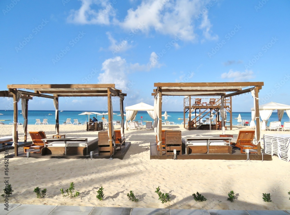 Beach cabanas and chairs on a white sandy beach