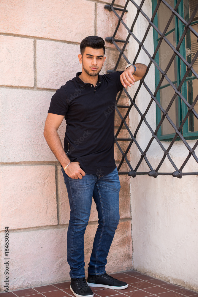 Young handsome male in jeans, tennis shoes and t-shirt Stock Photo | Adobe  Stock