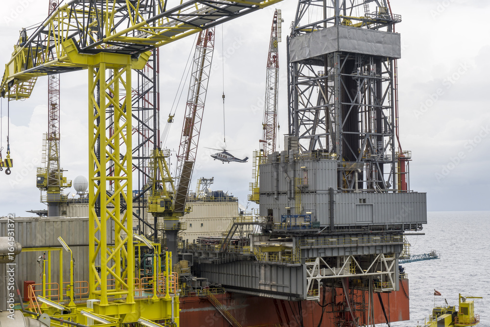 Oil and gas industrial. View of drilling rig with boom crane in resting ...