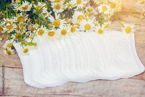 Sanitary pads with the scent of chamomile. Selective focus.  photo