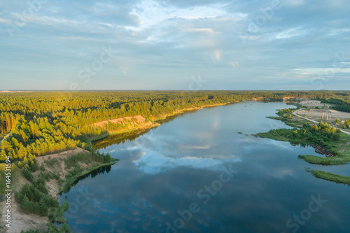 Beautiful sunset over the lake in summer forest. Aerial photography. © nikwaller