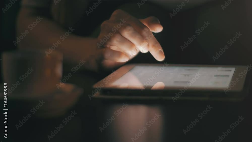 Woman using tablet pc at night. High quality 4K footage. UHD. Easily scales down to 1080p for high detail definition.