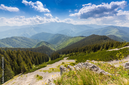 Mountain scenery in the Transylvanian Alps, on a bright summer day with blue skies and limestome cliffs photo