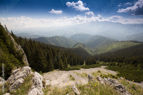 Mountain scenery in the Transylvanian Alps, on a bright summer day with blue skies and limestome cliffs photo