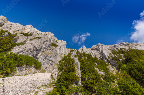 Mountain scenery in the Transylvanian Alps, on a bright summer day with blue skies and limestome cliffs photo