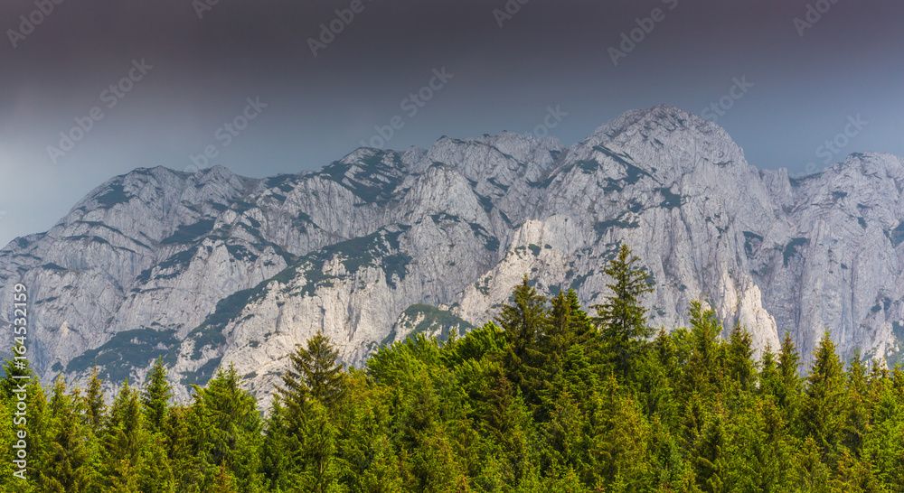 Dramatic scenery in Piatra Craiului Mountains, Romania, with beautiful mist clouds and limestone peaks Dramatic scenery in Piatra Craiului Mountains, Romania, with beautiful mist clouds and limestone peaks