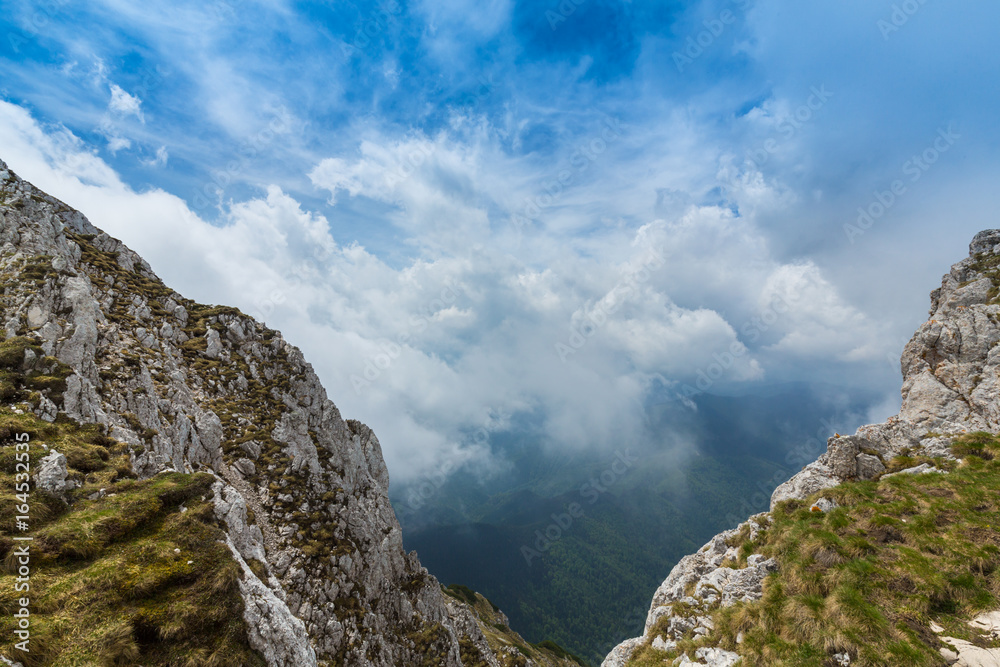 Beautiful mountain scenery with limestone rocks and storm clouds, in Piatra Craiului mountain range