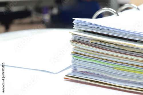 Pile of papers and documents on white table at workplace,office supplies,business concept.