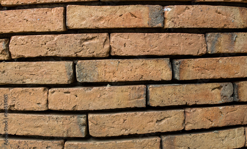 The background of the ancient brick wall is not very close together.