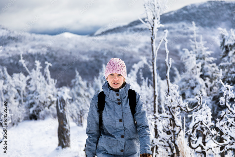 Woman Hiking High in the Mountains during Winter