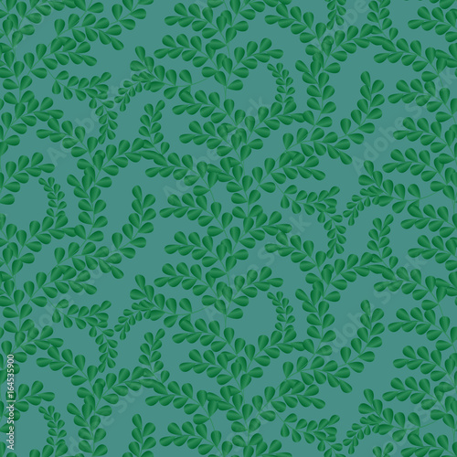 Seamless leaf pattern. Background in small green leaves on a blue background for textiles, fabric, cotton fabric, cover, wallpaper, stamp, gift wrap, postcard.