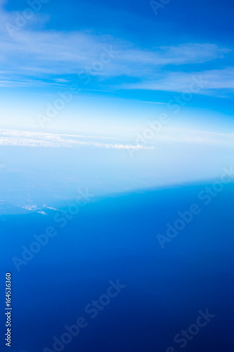 Clear blue sky. Aerial shot from the airplane window. Aircraft point of view.