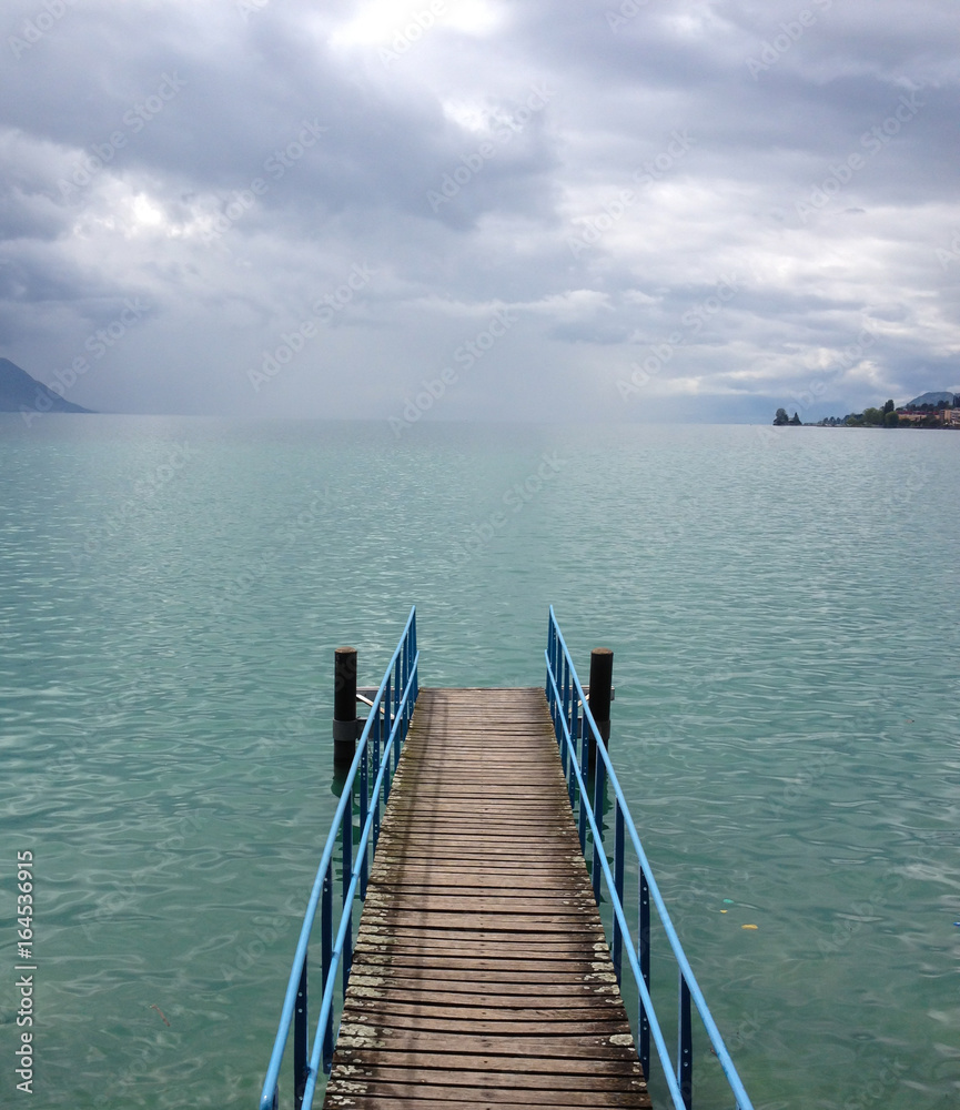 Pier before the rainstorm on the Lake Geneva, Switzerland, Europe. Abstract: cry, sad, tranquil, calm, quiet, cold, cool