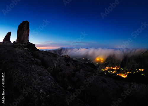 view of Roque Nublo peak and Artenara village by night, Gran Canaria, Spain
