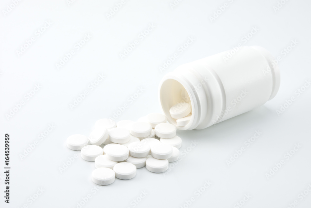 white pills pouring out of the pill bottle white pills pouring out of the pill bottle