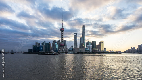 Shanghai skyline landmarks of Shanghai with Huangpu river at sunrise sunset in China.