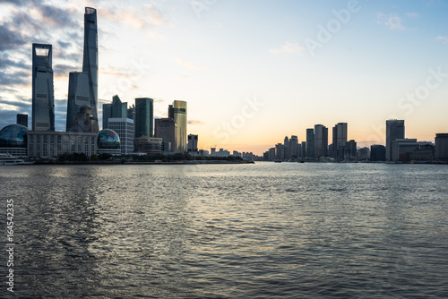 Shanghai skyline landmarks of Shanghai with Huangpu river at sunrise sunset in China.