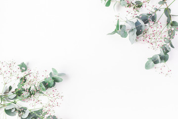 Flowers composition. Frame made of of pink gypsophila flowers and eucalyptus branches on white background. Flat lay, top view, copy space