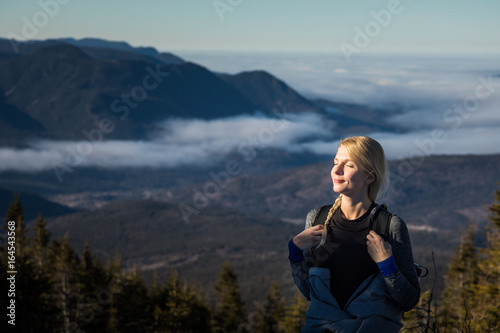 Woman Enjoying the Fresh Air of the Mountains while Hiking to the summit of the Richardson © aetb