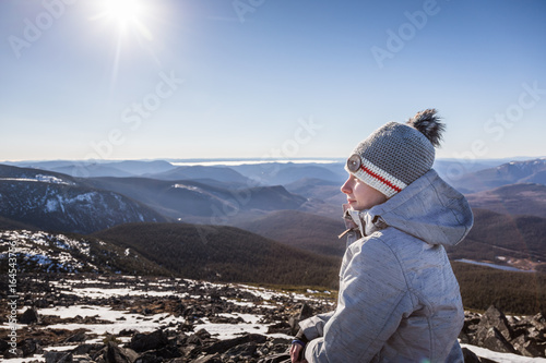 Happy Woman Enjoying the View of the Richardson Mountain's Summit