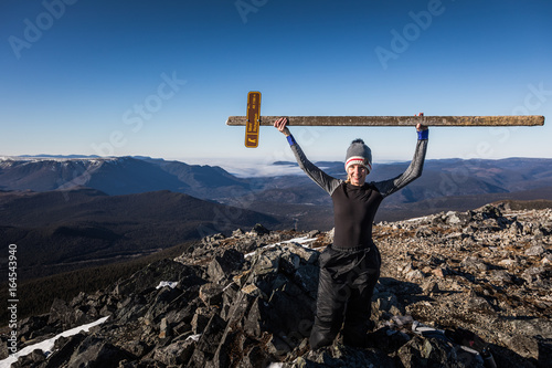 Fotografie Happy Woman Enjoying the Success of the Richardson Mountain's Summit
