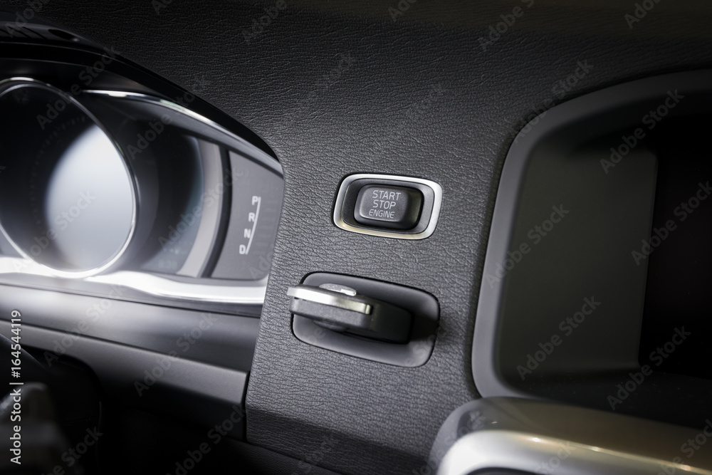 Engine start-stop button in a modern car interior