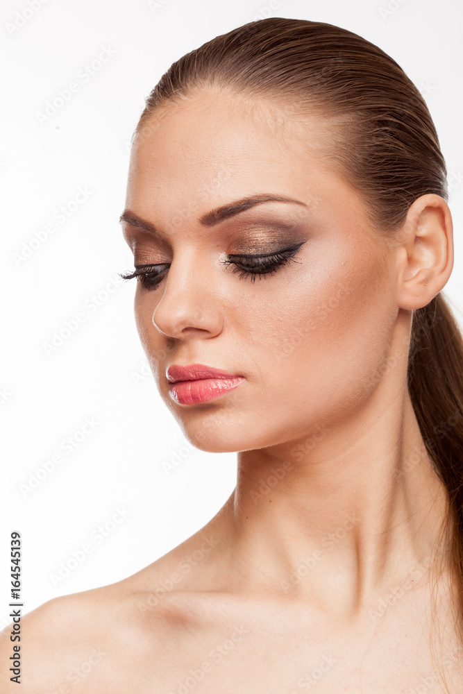 Blonde model with professional make up on white background