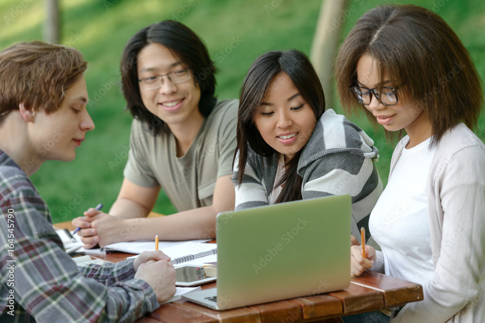 Multiethnic group of cheerful young students studying Multiethnic group of cheerful young students studying