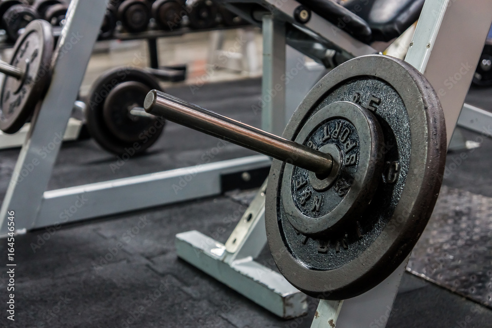 Barbell plates in a gym. They are fitness equipments.