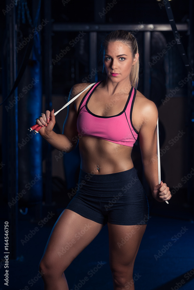Fitness female working out in the gym with a skipping rope