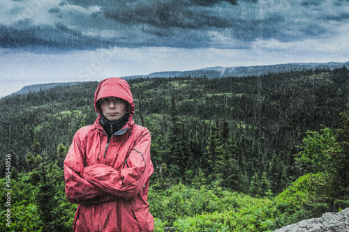 Tablou pe pânză Unpredictable Heavy Rain Pouring on a Sad and Frustrated Young Woman Getting Col