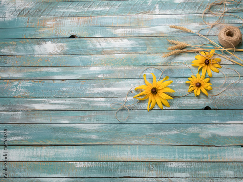 Summer old wooden background with yellow flowers