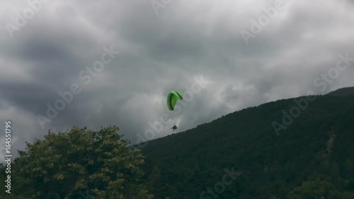 View of a tandem paraglider above the mountain valley. Flying in tandem. photo