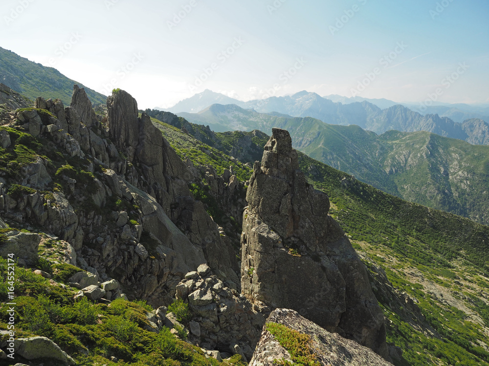 high mountain view scenery with sharp boulders nad blue sky