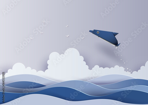 Origami made dolphin in the sea.The illustrations do the same paper art and craft style