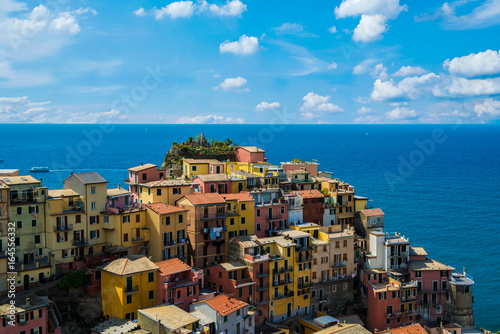 view of famous travel landmark destination Manarola colorful houses and nature, small mediterranean old sea town with harbour coast,Cinque terre National Park, Liguria, Italy. Summer sunny morning
