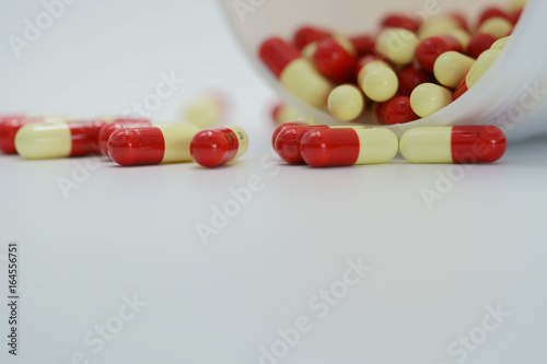 Capsule pills with bottle on white background