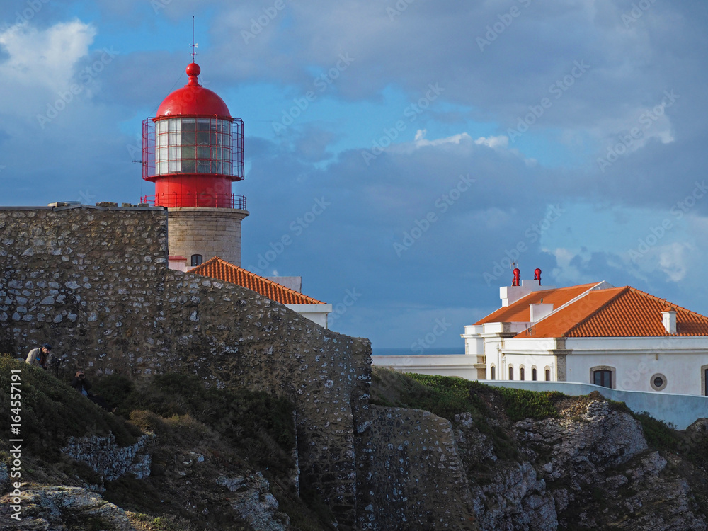 red lighthouse on Cabo de Sao Vicente with stone wall