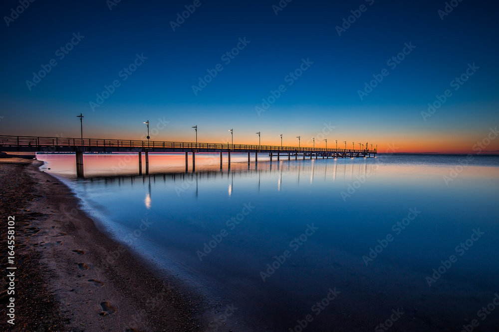 Fototapeta premium Amazing sunrise on the pier at the seaside. Gdynia Orlowo, Poland 