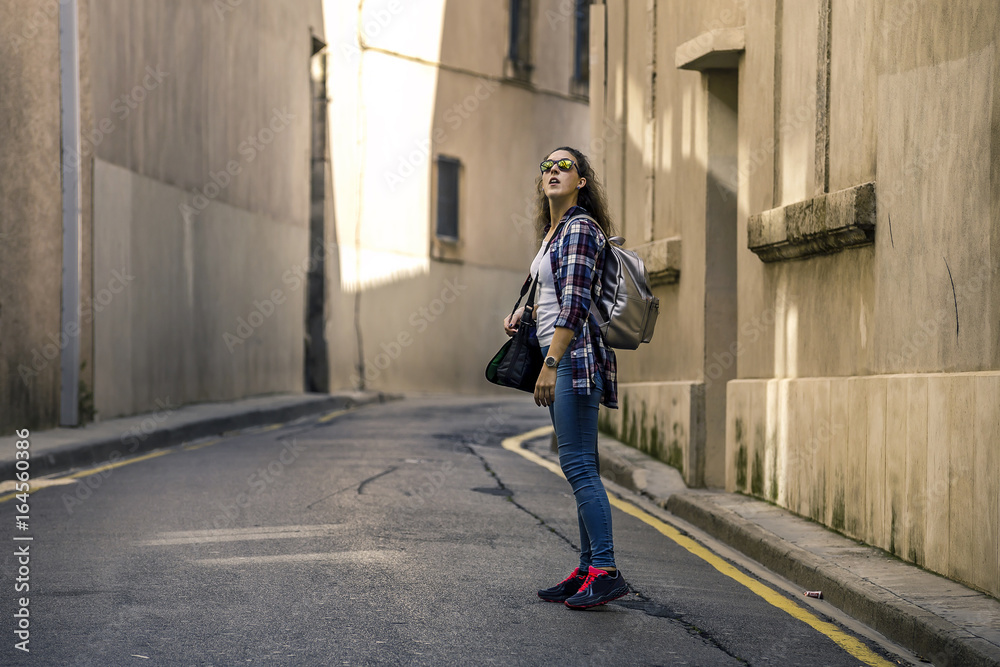 Portrait of young and attractive traveler walking by the street of old city, Narbonne, France