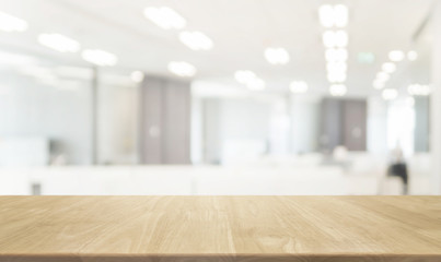 Wood table top and blurred bokeh office interior space background - can used for display or montage your products.