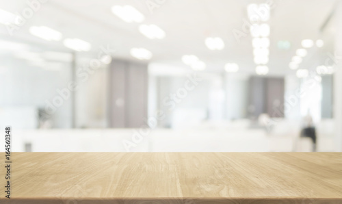 Wood table top and blurred bokeh office interior space background - can used for display or montage your products.