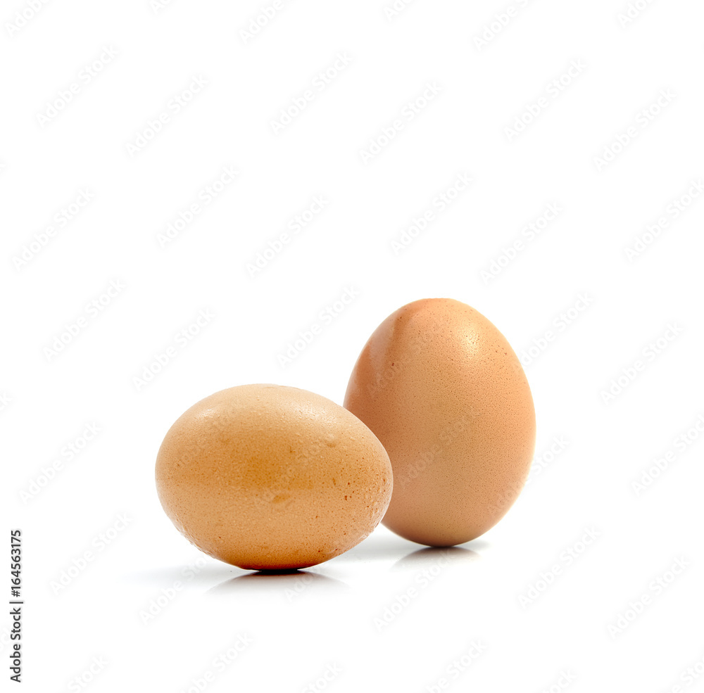 Two fresh hen eggs isolated against a white background. Two fresh hen eggs isolated against a white background.