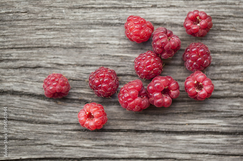 Raspberries on wooden background. Close up, top view, high resolution product.