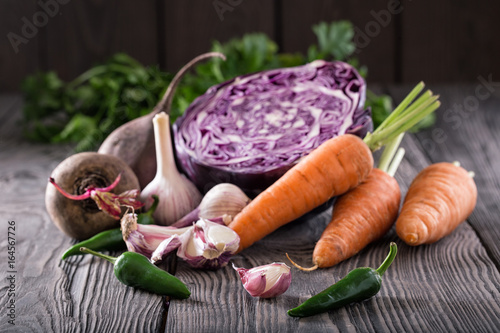 Vegetable still life on wooden table with wooden background