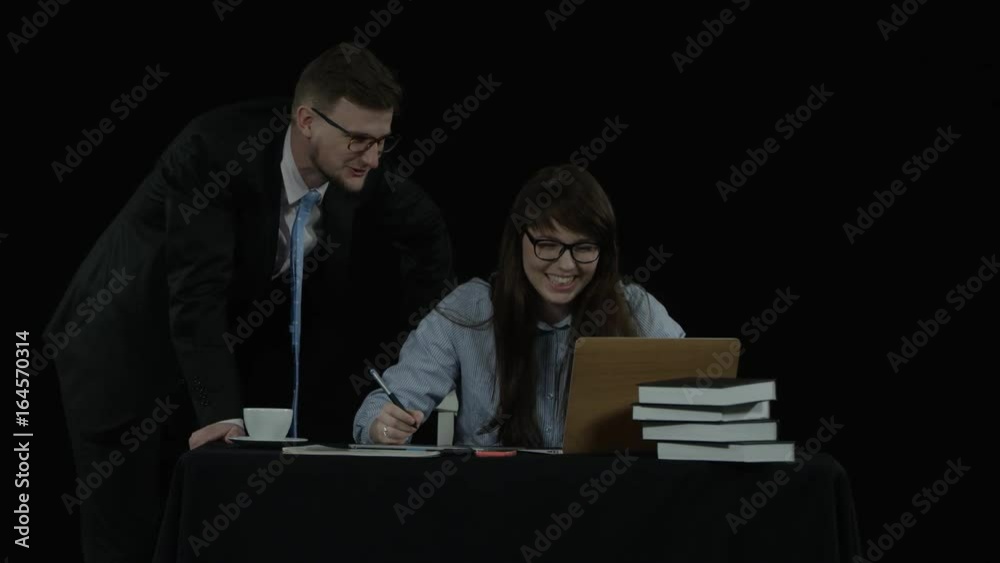 Two colleagues man and woman are happy with the results of their work Two colleagues man and woman are happy with the results of their work