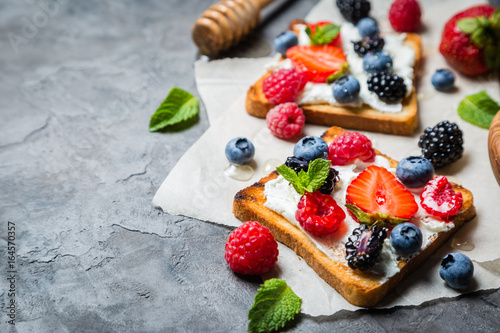 Selection of toasts with cheese peanut butter and berries