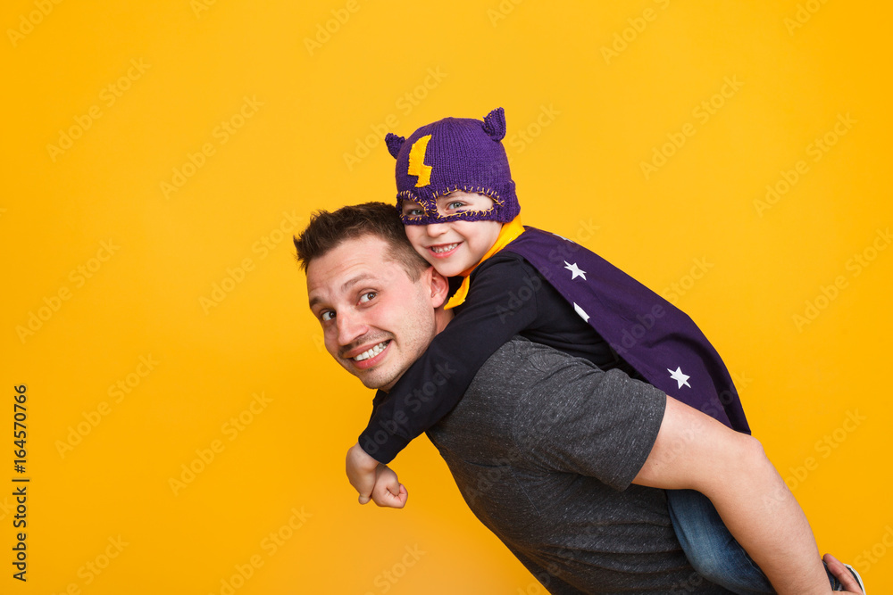 Father carrying son on back Father carrying son on back
